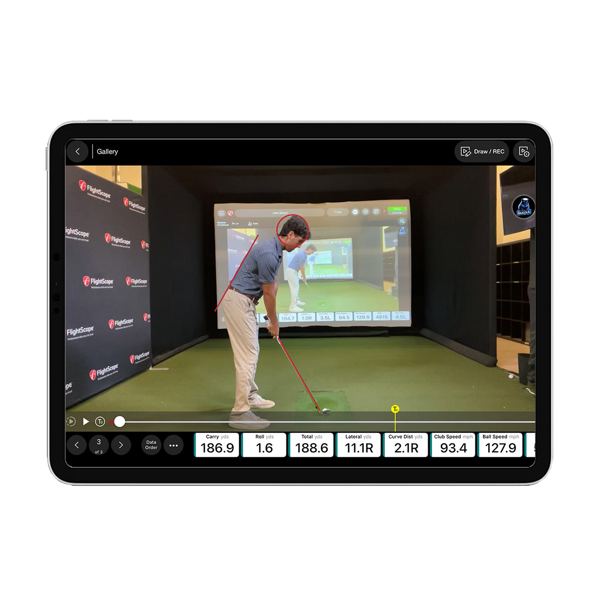 Golf simulator setup with a screen displaying a golfer on a virtual course.