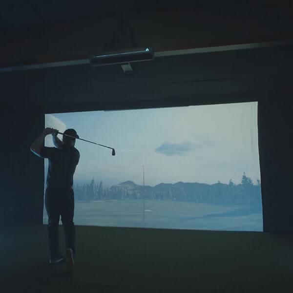 TruGolf APOGEE Launch Monitor Showing A Man Infront Of Screen